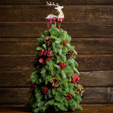 A Table top tree made of noble fir with 8 Australian Cones, 12 red berry clusters, 6 small Tartan bows, and a wooden reindeer with a wood background. 