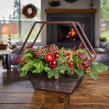 Centerpiece with noble fir, cedar, and pine with 2 ponderosa pine cones, 2 Australian pine cones, 1 red ball cluster, 4 red berry branches, 2 red plaid bow tucks, and a hexagon metal and wooden container on a wooden table