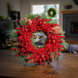 Christmas wreath made of noble fir and white pine with a ring of faux red pepperberries, red ball clusters, and white-pine cones on a wreath stand