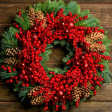 Christmas wreath made of noble fir and white pine with a ring of faux red pepperberries, red ball clusters, and white-pine cones