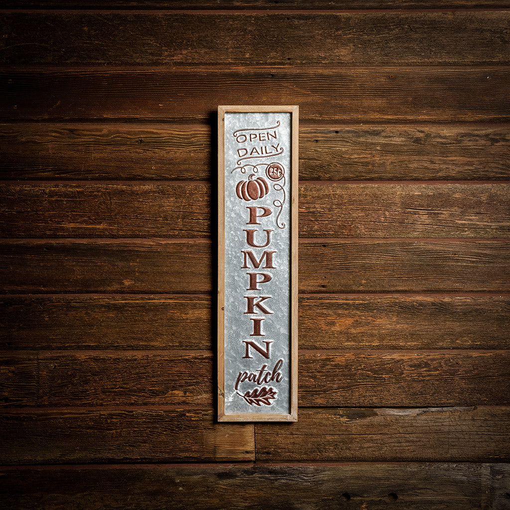 Pumpkin Patch 27 inch metal and wood sign hung on a dark wooden background.