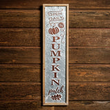 Pumpkin Patch 27 inch metal and wood sign hung on a dark wooden background.