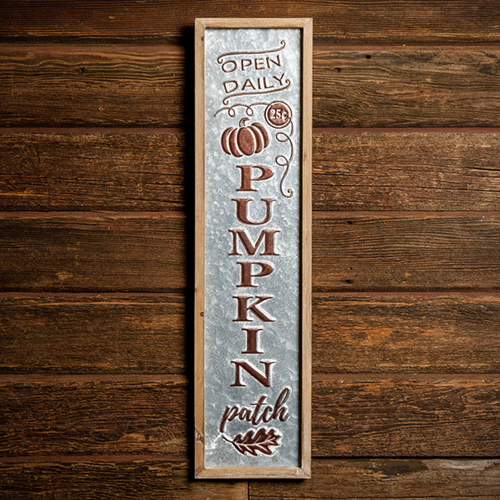 Pumpkin Patch 27 inch metal and wood sign hung on a dark wooden background.