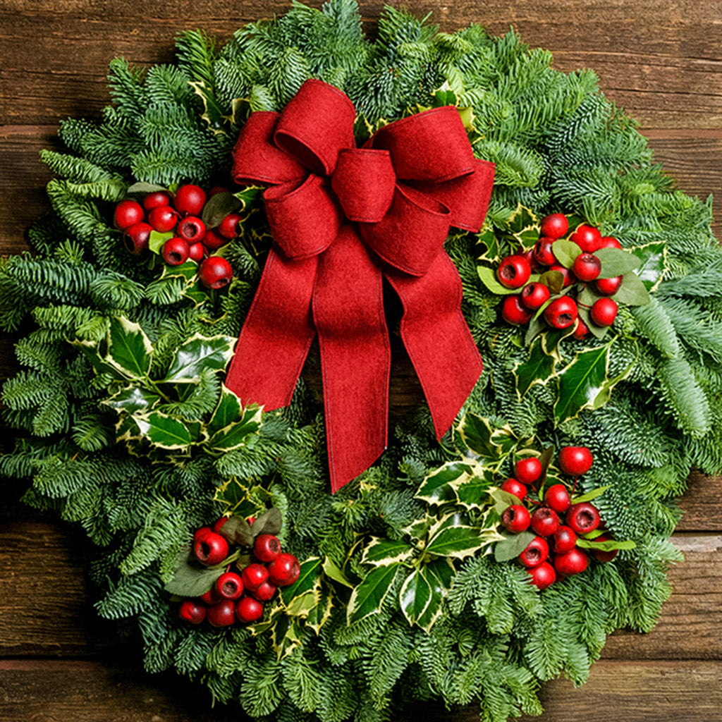 Christmas wreath made of noble fir and variegated holly with 4 country-berry clusters and a red brushed-linen bow